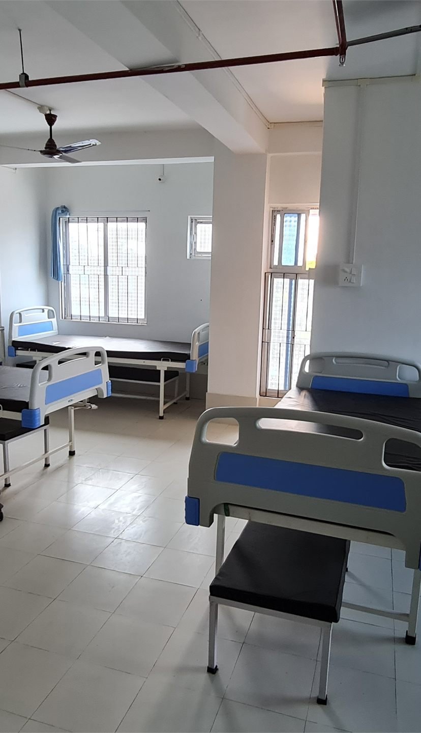 A clean inpatient ward with hospital beds
